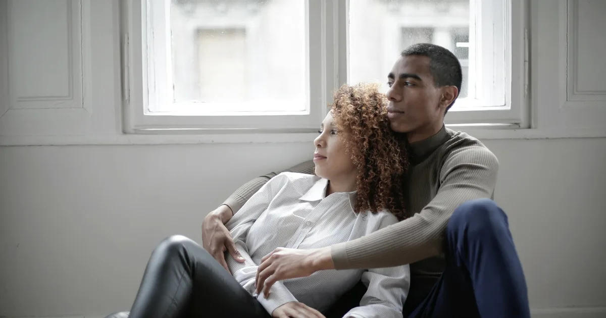 A couple embracing near a window, in a calm moment