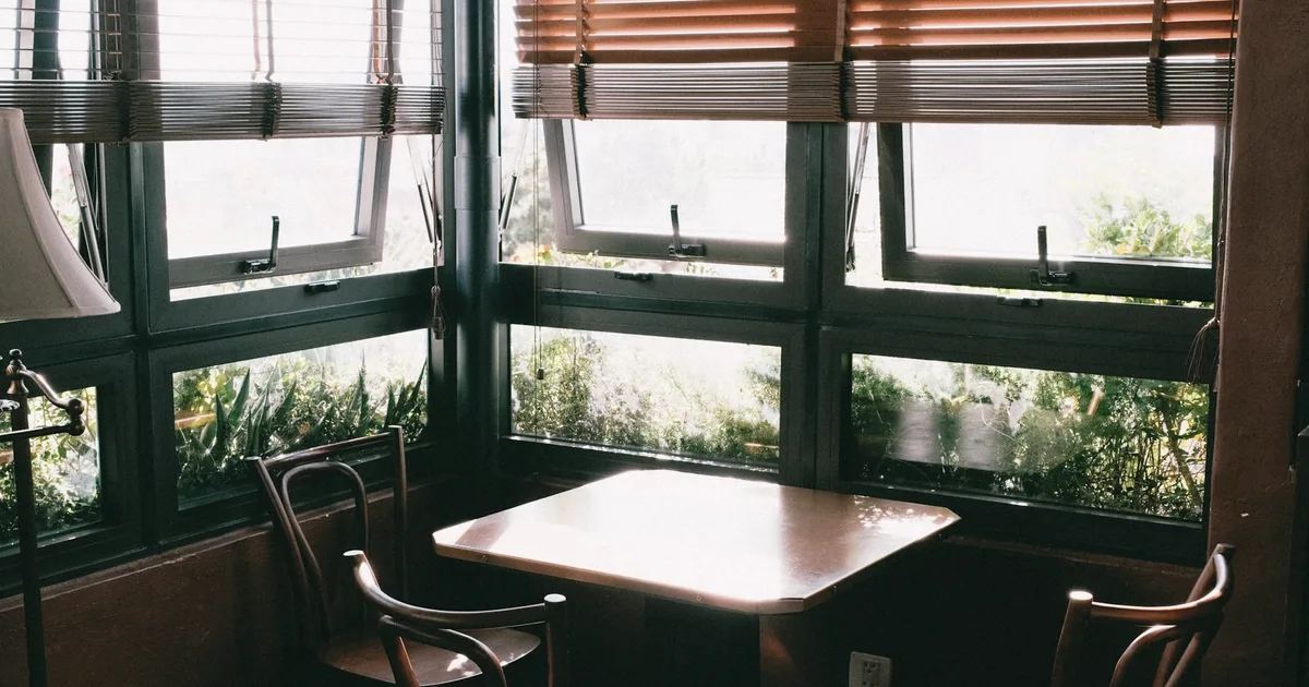 An empty dining corner by a window in soft light