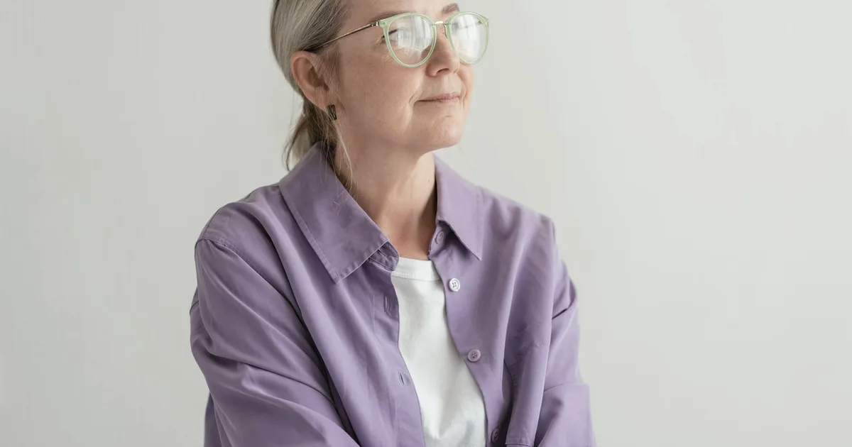 Older woman with a pensive expression in soft natural light
